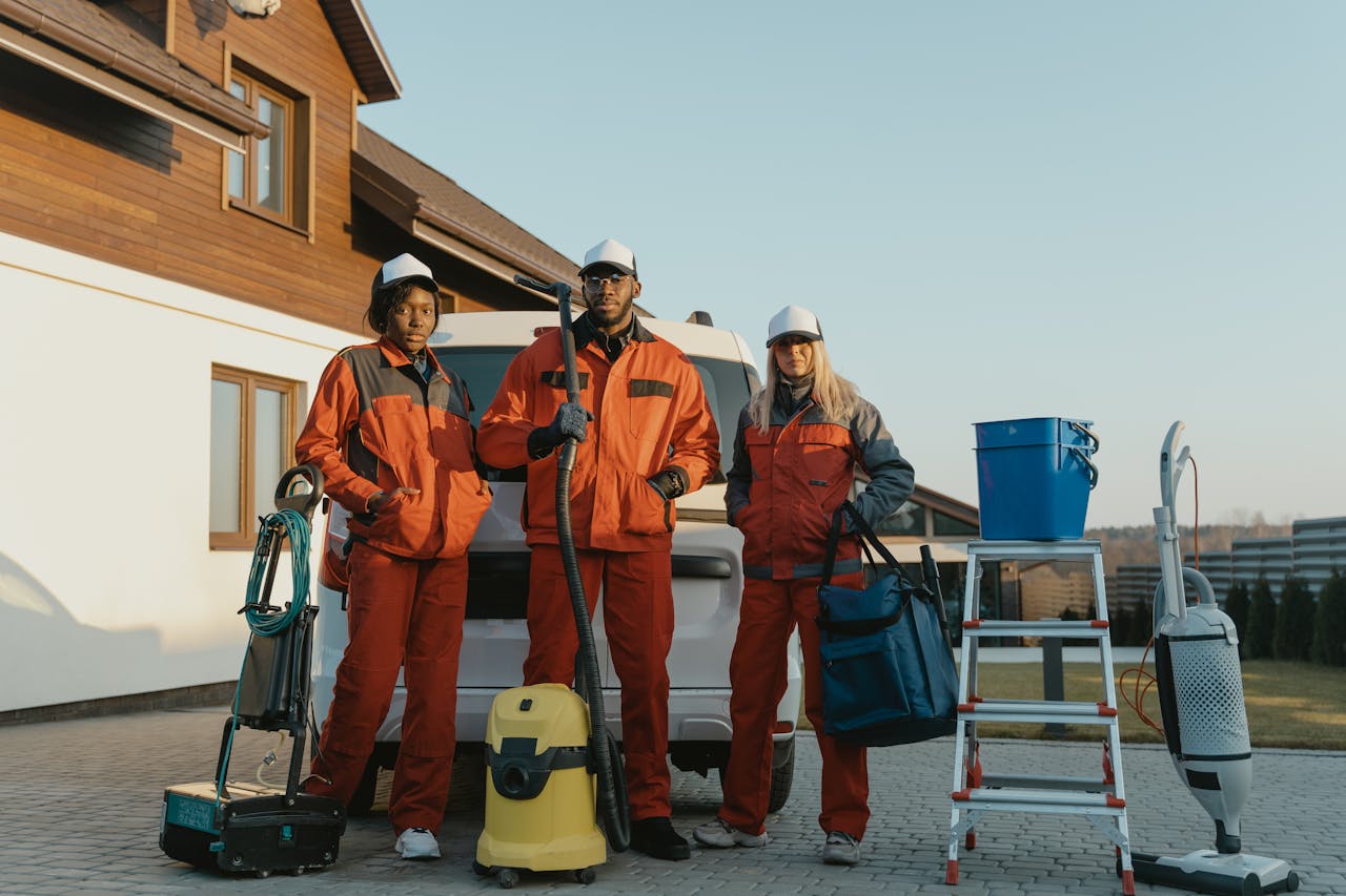 our-journey-01 Group of workers in protective gear standing beside equipment outdoors.